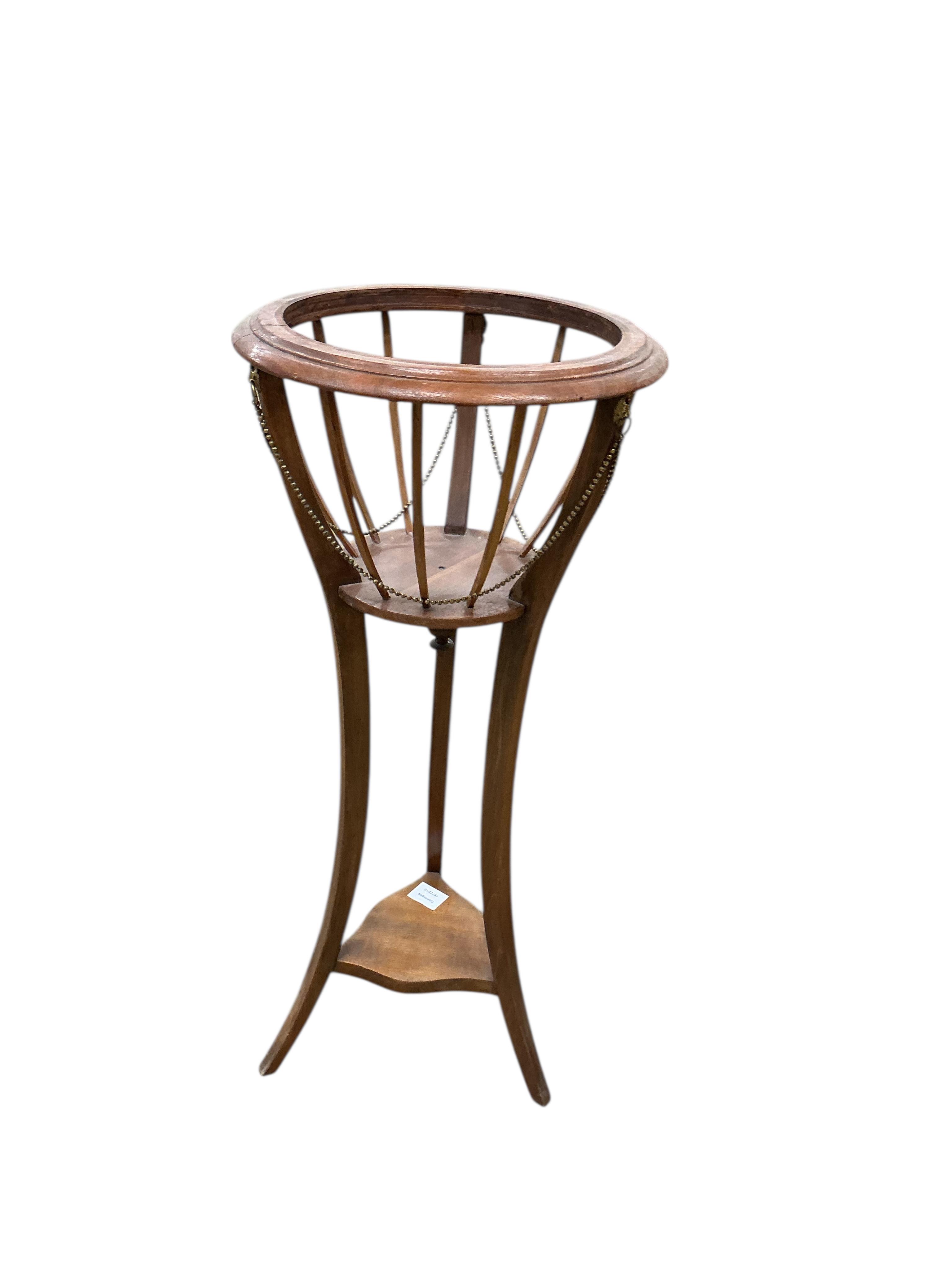 An Edwardian mahogany jardiniere with brass liner, height 85cm